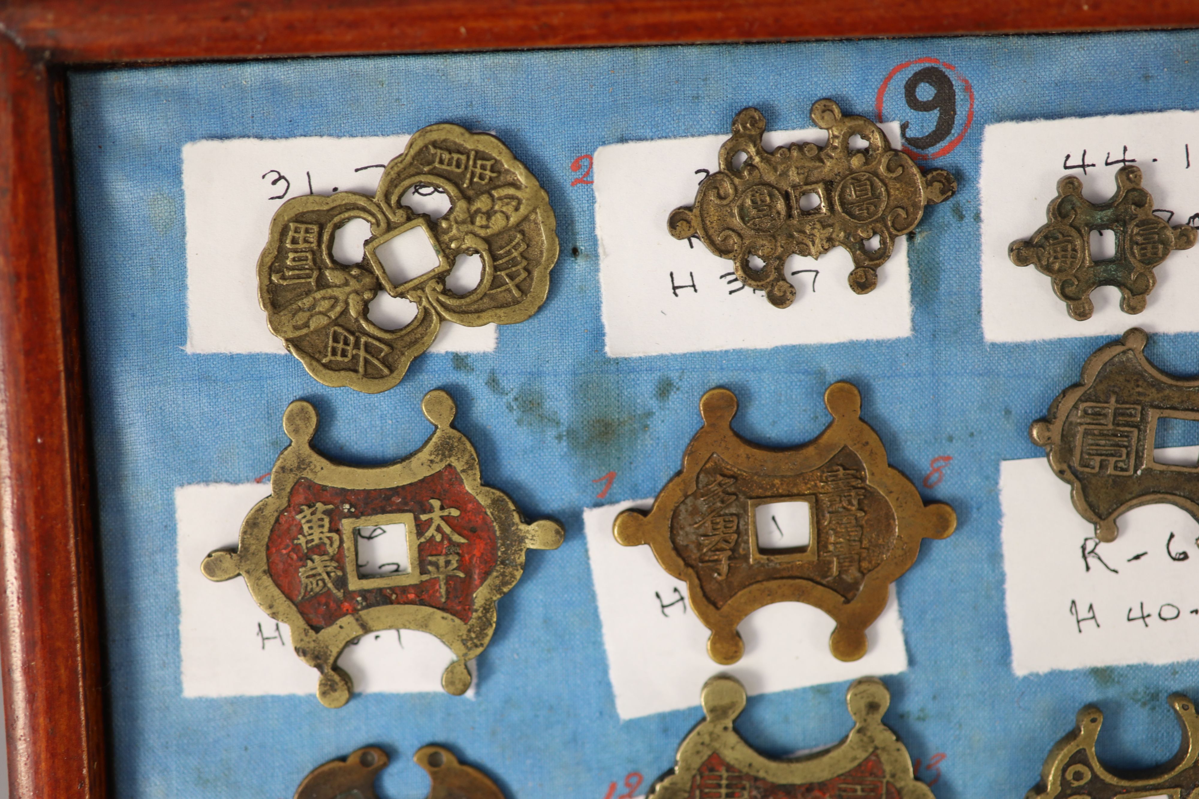 A group of 99 Korean bronze and metal amulets or charms, 19th/20th century